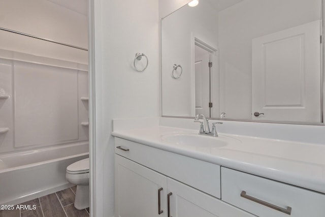 full bath featuring wood tiled floor, shower / tub combination, vanity, and toilet