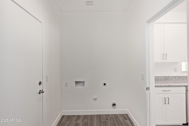 laundry room with dark wood-style flooring, hookup for a washing machine, hookup for an electric dryer, laundry area, and baseboards