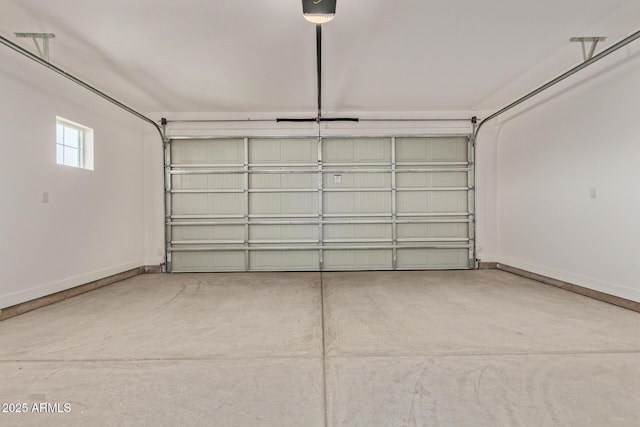 garage with a garage door opener and baseboards