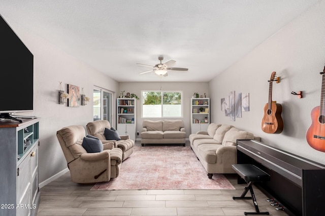 living area featuring a ceiling fan, wood finish floors, and baseboards