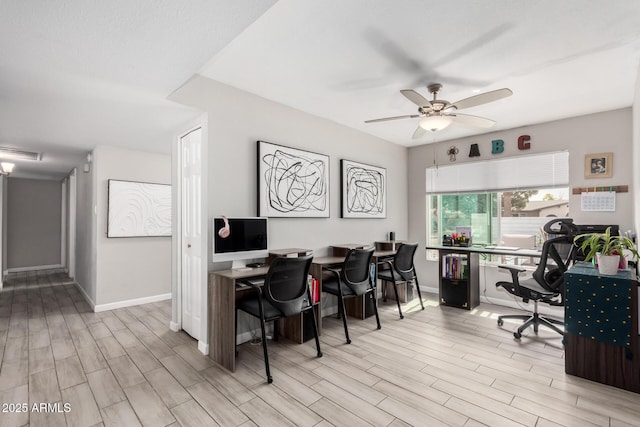 home office featuring baseboards, wood tiled floor, visible vents, and a ceiling fan