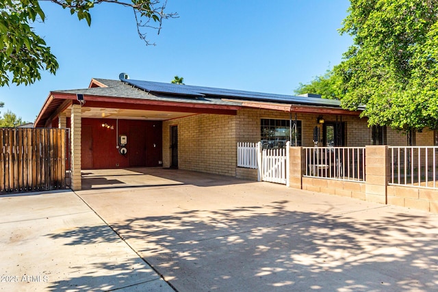 2110 W Morrow Dr, Phoenix, AZ 85027 - ranch-style home featuring concrete driveway, solar panels, and a gate
