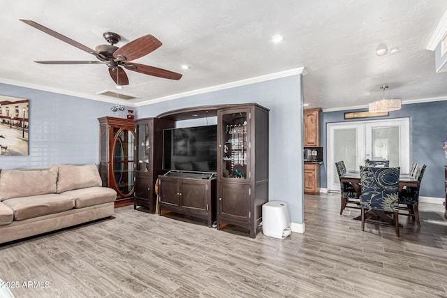 2110 W Morrow Dr, Phoenix, AZ 85027 - living room featuring baseboards, wood finished floors, ceiling fan, ornamental molding, and recessed lighting
