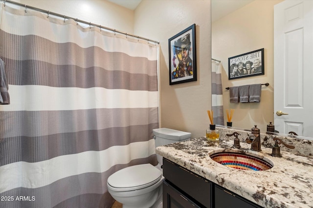 bathroom with toilet and vanity