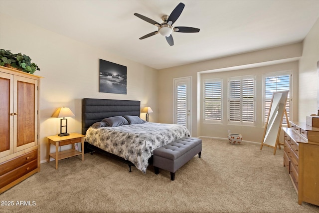 bedroom featuring multiple windows, light colored carpet, baseboards, and a ceiling fan