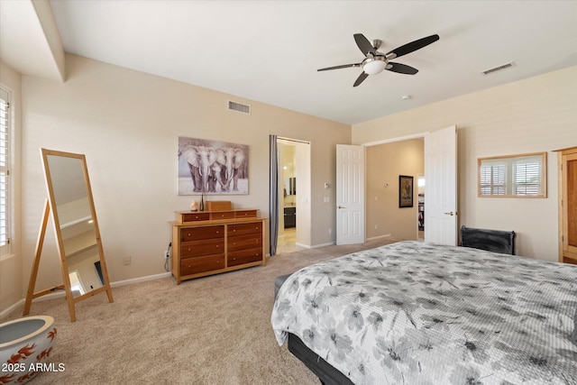 bedroom with light colored carpet, baseboards, ensuite bathroom, and a ceiling fan