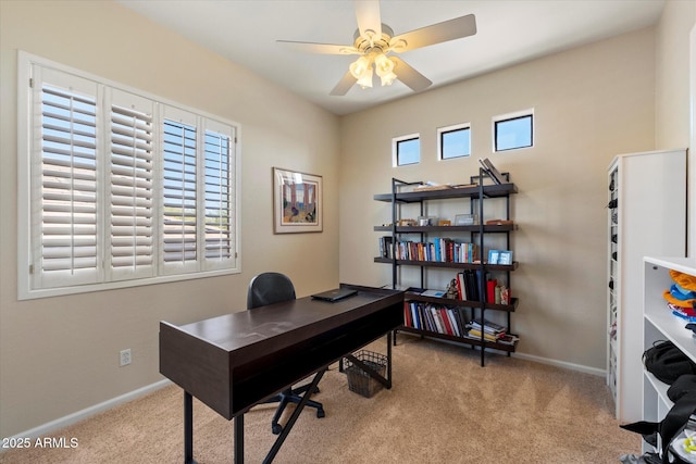 office area with carpet floors, baseboards, and ceiling fan