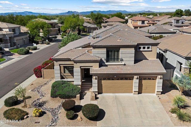 view of front of property with stucco siding, a garage, concrete driveway, and a residential view