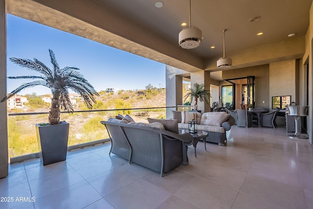 view of patio with a balcony and outdoor lounge area