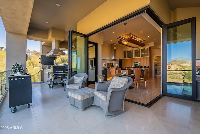 view of patio featuring a mountain view and a balcony