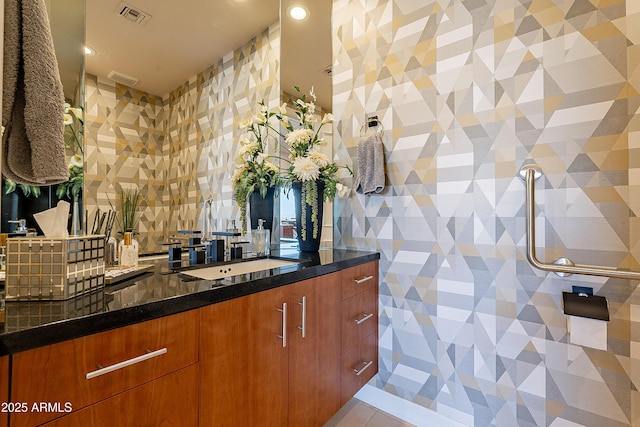 interior space featuring light tile patterned floors and dark stone countertops