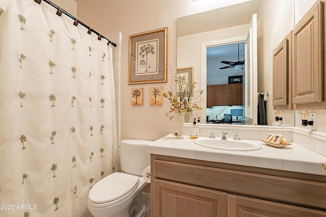 bathroom featuring vanity, ceiling fan, and toilet