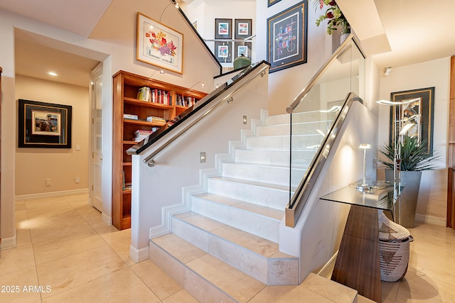 staircase featuring tile patterned flooring