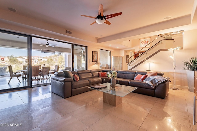 tiled living room with ceiling fan