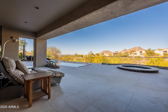 view of patio / terrace with an in ground hot tub