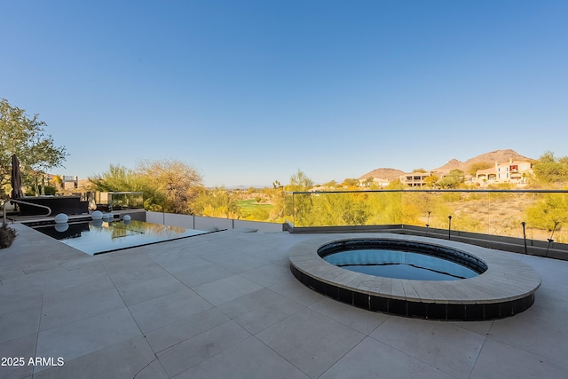 view of swimming pool featuring an in ground hot tub and a patio