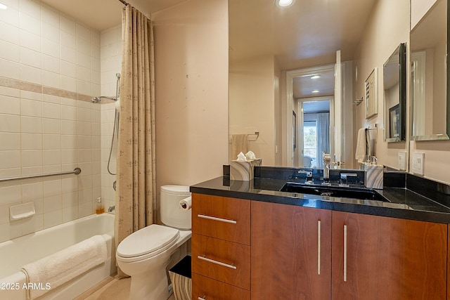 full bathroom with vanity, shower / tub combo, and toilet