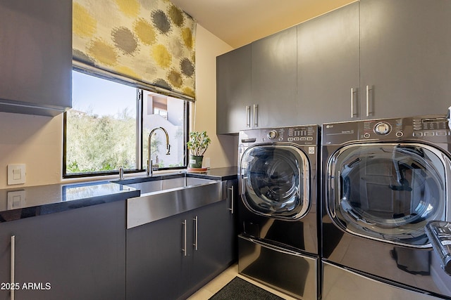 laundry area with cabinets, sink, and washing machine and clothes dryer