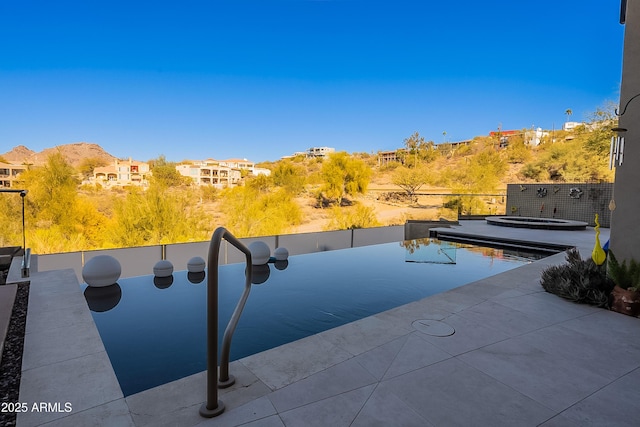 view of swimming pool featuring an in ground hot tub