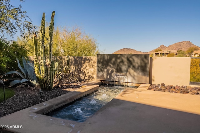 exterior space featuring a mountain view and a patio area