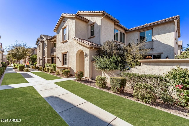 mediterranean / spanish-style house with a front lawn