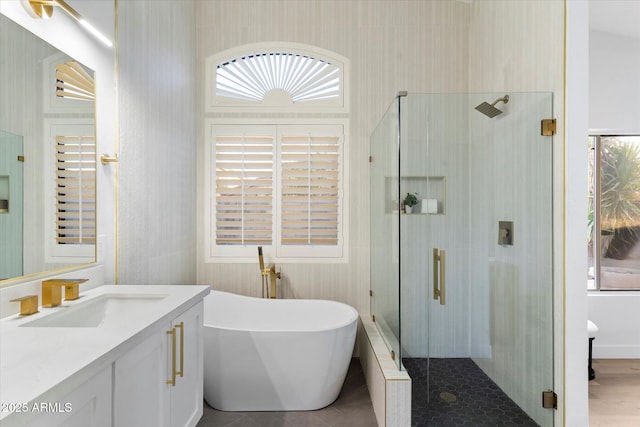 bathroom featuring vanity and shower with separate bathtub