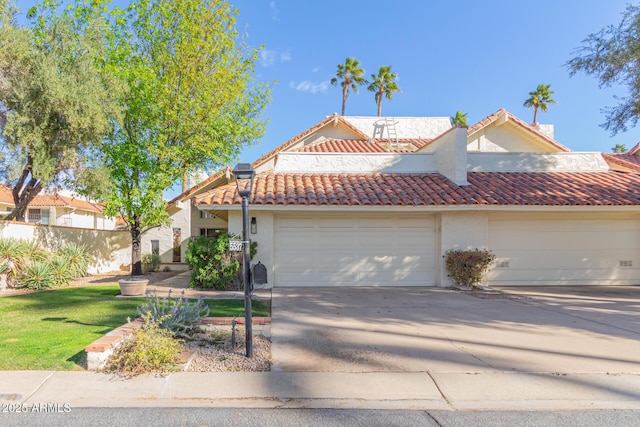 view of front of property featuring a garage and a front lawn