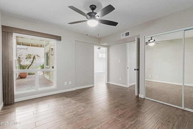 unfurnished bedroom with ceiling fan and wood-type flooring