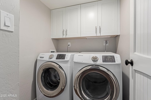 laundry area featuring cabinets and separate washer and dryer