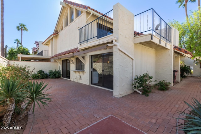 back of property with a patio area and a balcony