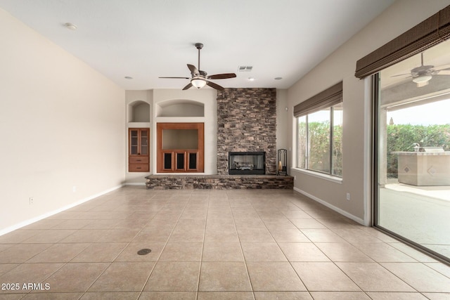 18359 W Sweet Acacia Dr, Goodyear, AZ 85338 - unfurnished living room with a ceiling fan, light tile patterned floors, and baseboards