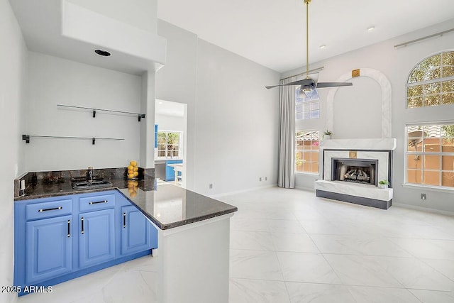 16219 S 14th Way, Phoenix, AZ 85048 - kitchen featuring light marble finish floors, healthy amount of natural light, blue cabinets, and a sink