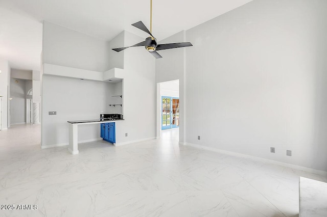 16219 S 14th Way, Phoenix, AZ 85048 - unfurnished living room featuring a ceiling fan, light marble finish floors, baseboards, and a towering ceiling