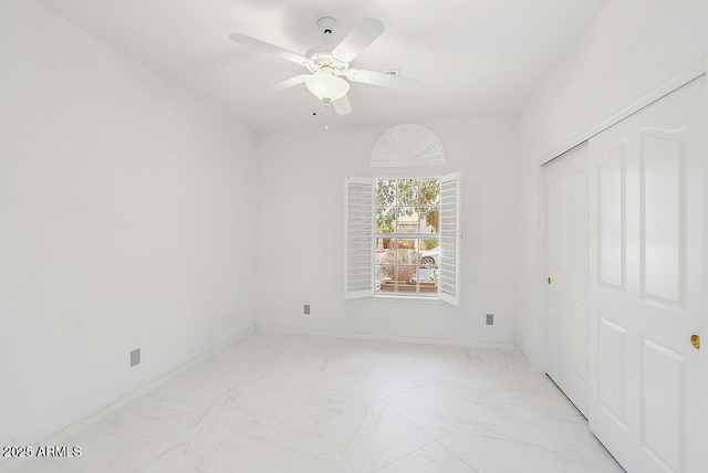16219 S 14th Way, Phoenix, AZ 85048 - unfurnished bedroom with light marble finish flooring, a closet, ceiling fan, and baseboards