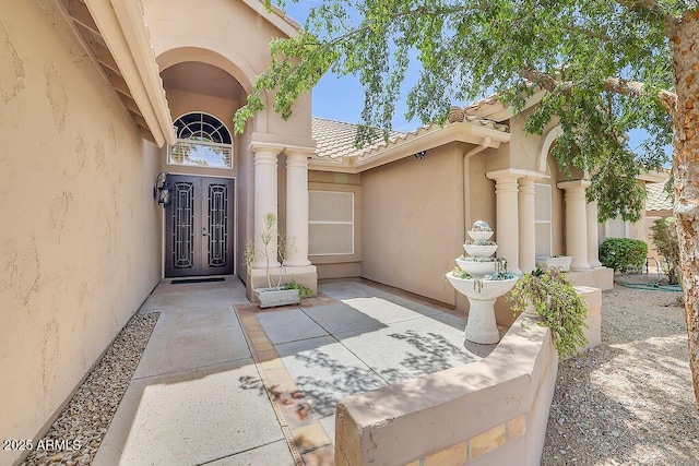 16219 S 14th Way, Phoenix, AZ 85048 - doorway to property with french doors, stucco siding, a tiled roof, and a patio