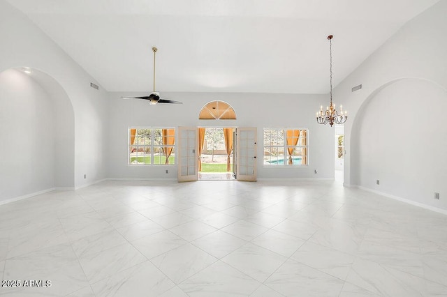 16219 S 14th Way, Phoenix, AZ 85048 - unfurnished living room featuring a chandelier, light marble finish flooring, arched walkways, baseboards, and high vaulted ceiling