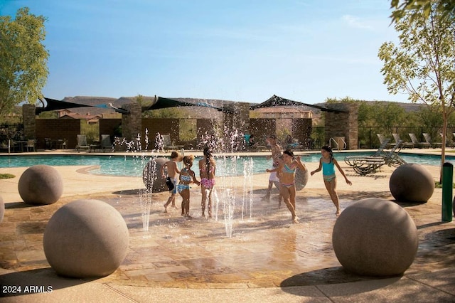 view of pool with pool water feature