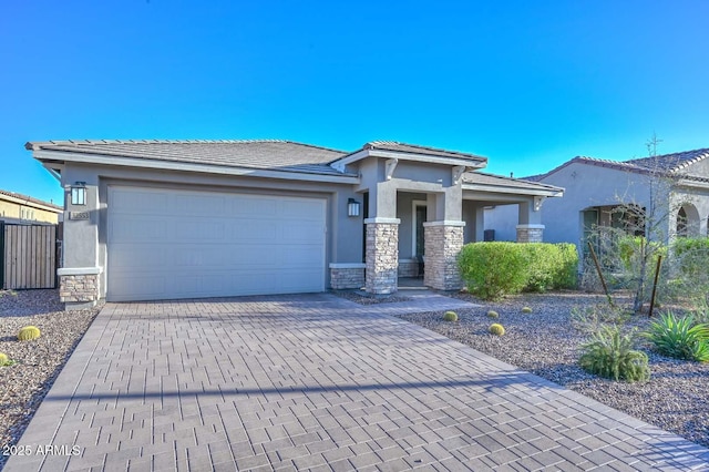 32553 N 133rd Ave, Peoria, AZ 85383 - prairie-style house featuring a tile roof, stone siding, decorative driveway, and stucco siding