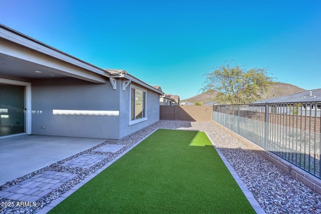 view of yard with a mountain view and a patio