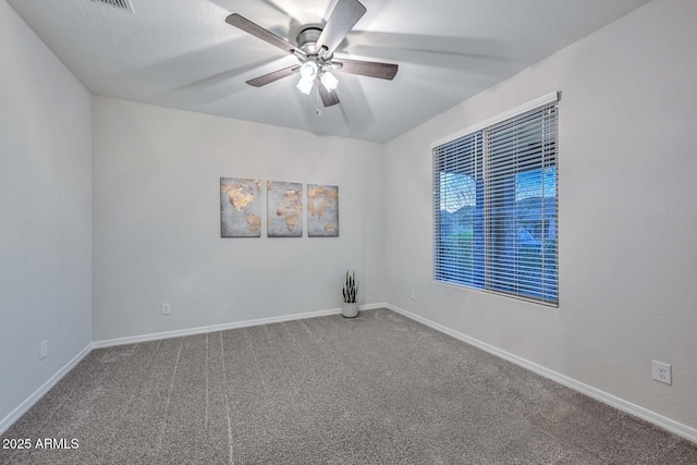 empty room with ceiling fan and carpet