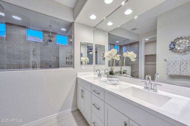 bathroom featuring vanity and a tile shower