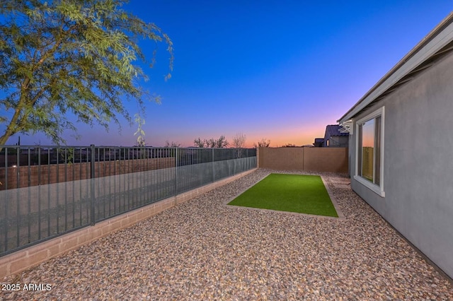 view of yard at dusk