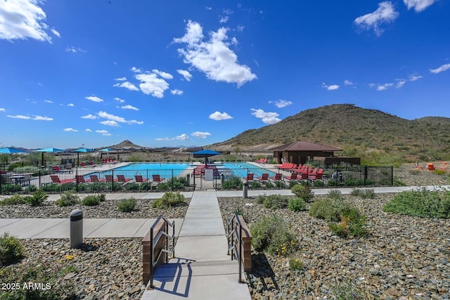 view of community featuring a pool, a gazebo, a mountain view, and a patio area