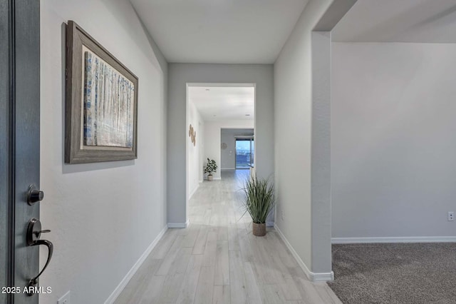 corridor with light wood-type flooring