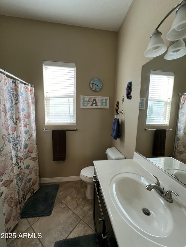 bathroom featuring curtained shower, toilet, vanity, tile patterned flooring, and baseboards