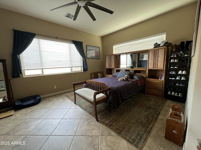 bedroom featuring ceiling fan, multiple windows, visible vents, and vaulted ceiling