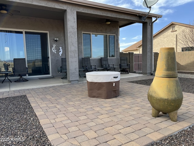 view of patio featuring ceiling fan and fence