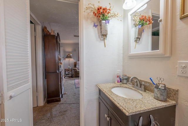 bathroom with vanity and a textured ceiling