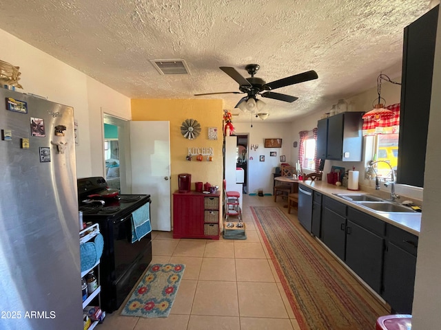 kitchen featuring sink, decorative light fixtures, light tile patterned floors, appliances with stainless steel finishes, and ceiling fan