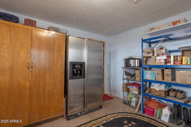 kitchen featuring stainless steel fridge with ice dispenser and a textured ceiling